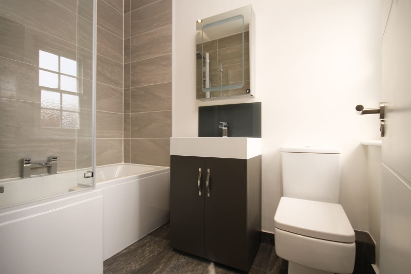 vanity, toilet, stylish, elegance, shower, black, indoors, luxury, domestic bathroom, tiled floor, sink, apartment, household equipment, faucet, contemporary