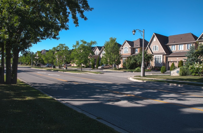 sunlight, architecture, building, residential district, day, houses, building exterior, housing, row house, homes, street, clear sky, tree, suburbs, outdoors
