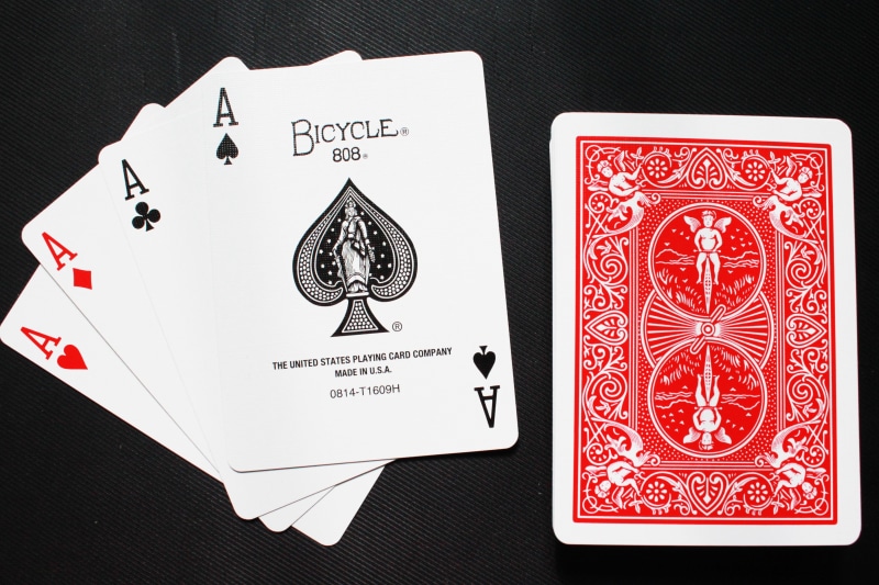 indoors, gaming, close-up, no people, bicycle, text, communication, letter, ace, arts culture and entertainment, magic cards, postage stamp, cards, red