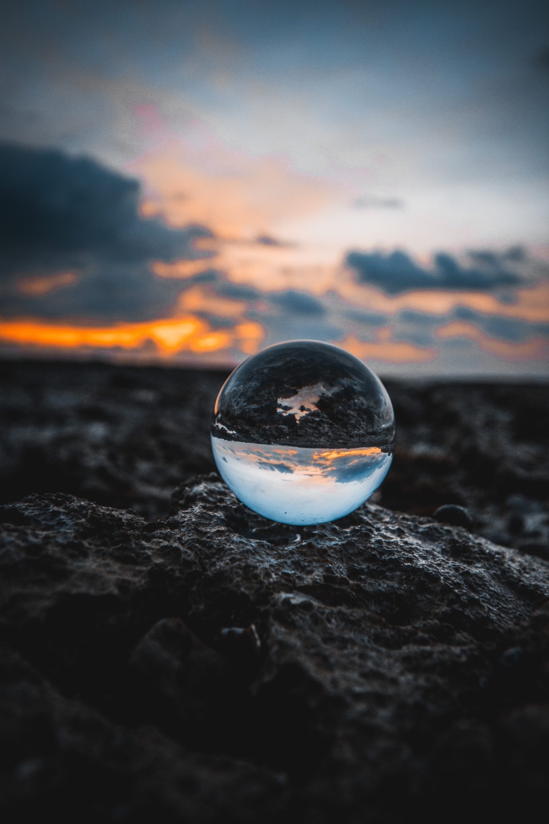 horizon over water, glass - material, solid, view, water, mer, dof, outdoors, abstract, crystal ball, rock - object, rock, sunset, hour, beach, globe, reflect