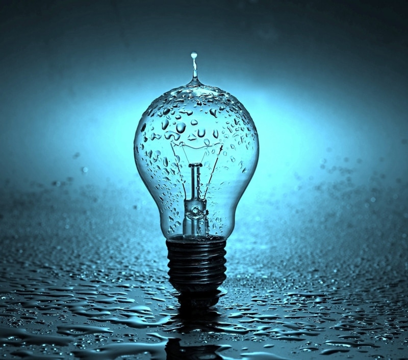 illuminated, light bulb, close-up, wet, no people, filament, spray, drops, vignette, water, studio shot, energy, drop, indoors, lamp, transparent, glass - material