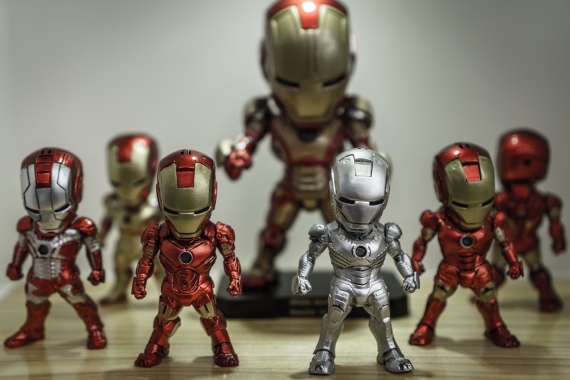 costume, day, play, robot, still life, representation, focus on foreground, toys, silver colored, indoors, no people, group of objects, photo, table, human representation