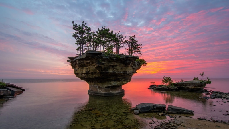 beach, outdoors, tree, stones, scenics - nature, solid, reflection, leafed, sea, orange color, green, 1080P, landscape, trees, rock, cloud - sky, sky