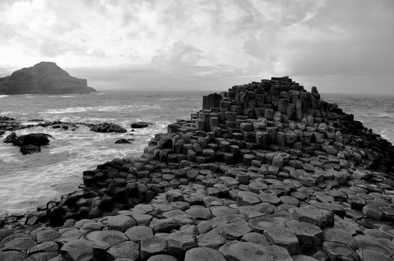 horizon over water, clouds, tranquil scene, rock - object, beauty in nature, water, horizon, rock formation, sky, sea, landscape, waves, monochrome, photography