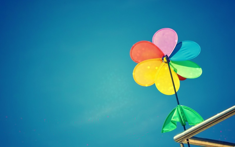 studio shot, fragility, blue background, environmental conservation, low angle view, blue, multicolored, wind, the sky, close-up, colored background, mill
