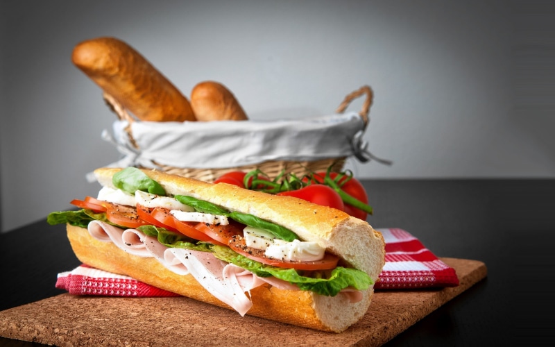 focus on foreground, indoors, freshness, wellbeing, studio shot, still life, sandwich, lettuce, table, healthy eating, baguette, breakfast, tomato, 2K