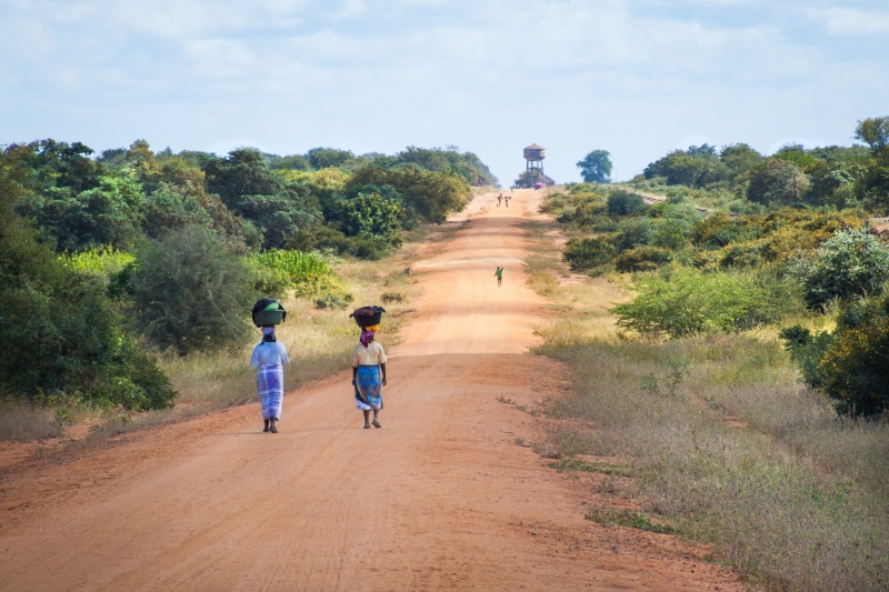 african women walking along road, dirt road, transportation, day, rear view, adult, nature, two people, walking, mozambique, childhood, men, the way forward
