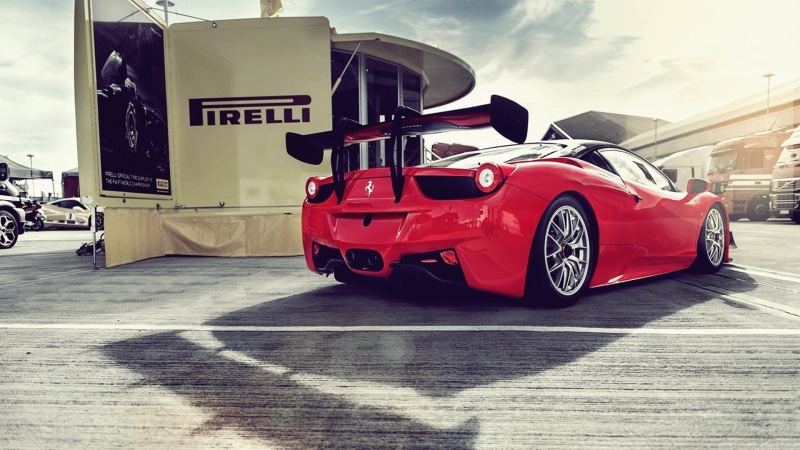 outdoors, red, transportation, sign, street, communication, road, sports, mode of transportation, Ferrari, land vehicle, text, sunlight, red cars, car