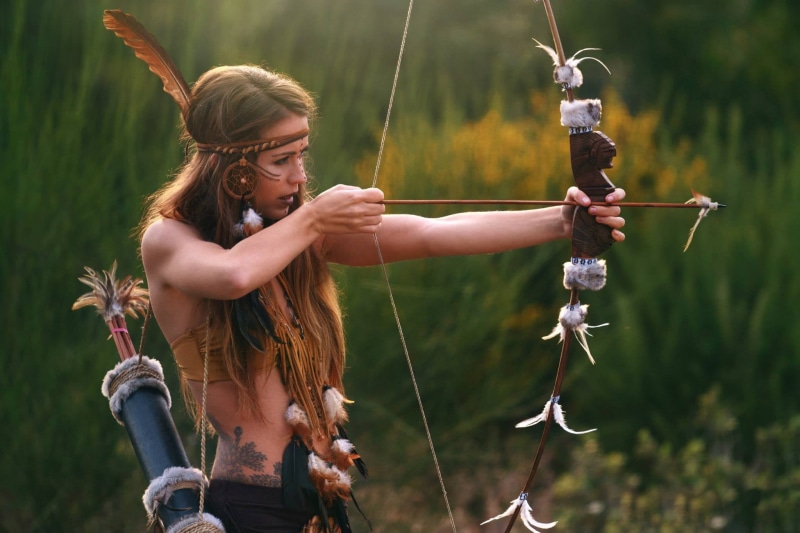 holding, nature, flower, girls, model, leisure activity, casual clothing, females, one person, lifestyles, real people, archer, young women, land, day