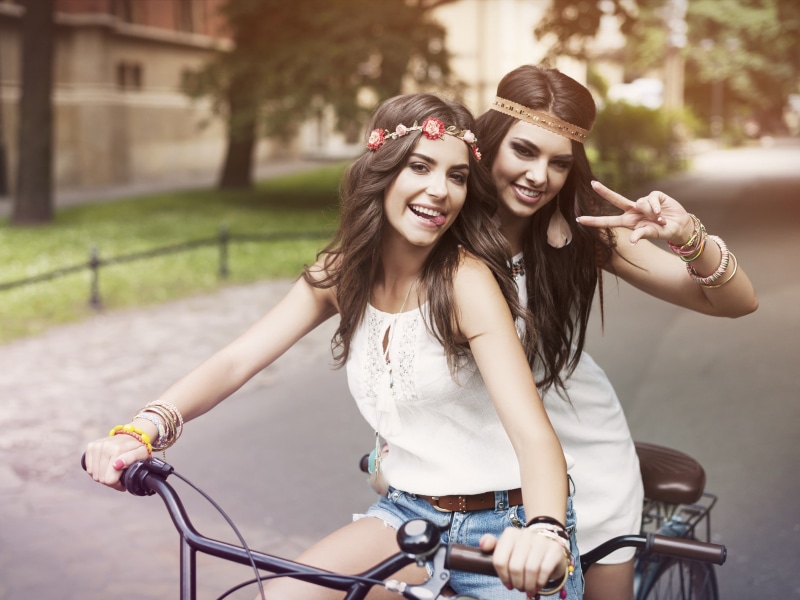 bicycle, young adult, fashion, lifestyles, jean shorts, smiling, 2K, model, adult, two people, tongue out, headband, positive emotion, hairstyle, transportation
