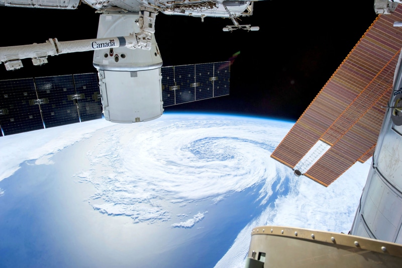 space travel vehicle, clouds, cold temperature, transportation system, spacecraft, solar panel, steel, satellite view, indoors, planet, snow, transportation