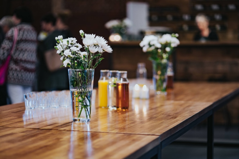 food, vase, decor, flower head, glass, joint, indoors, chair, container, focus on foreground, Interior, glass - material, cafe, pub, bar, freshness, selective focus