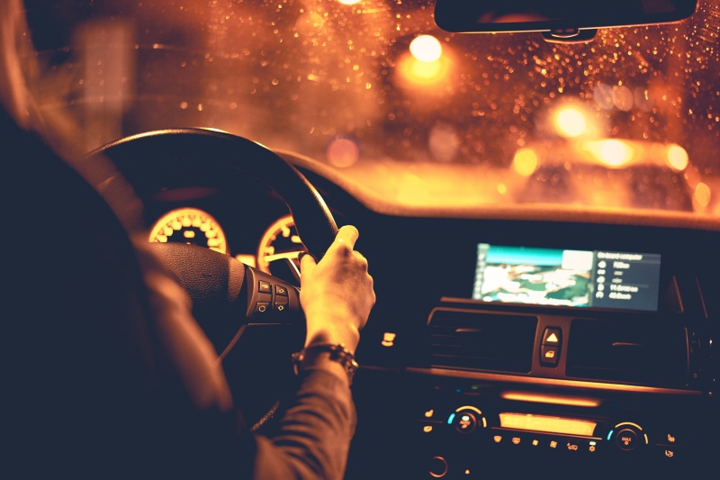 men, windshield, mode of transportation, one Person, motor vehicle, orange, real people, driver, Woman, speedometer, human body part, dashboard, at Night