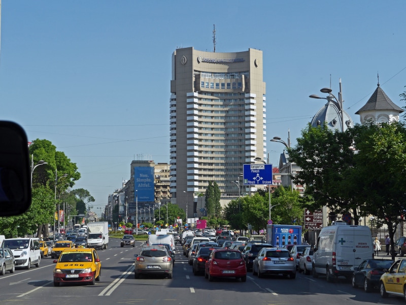skyscraper, transportation, main thoroughfare, street, no people, sky, car, built structure, morning traffic, eight lanes, tree, roundabout, cross-traffic