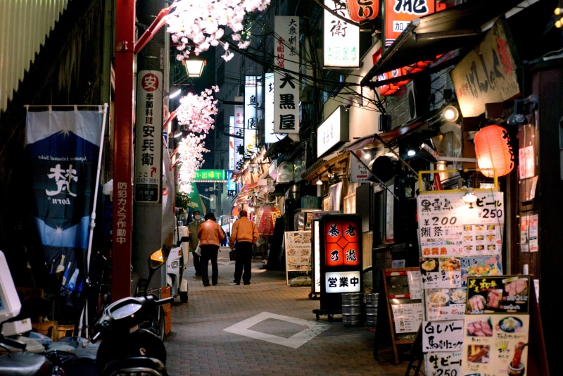 people, asia, street, city, person, capital, text, communication, shirt, stores, men, group of people, building exterior, japan, non-western script, night