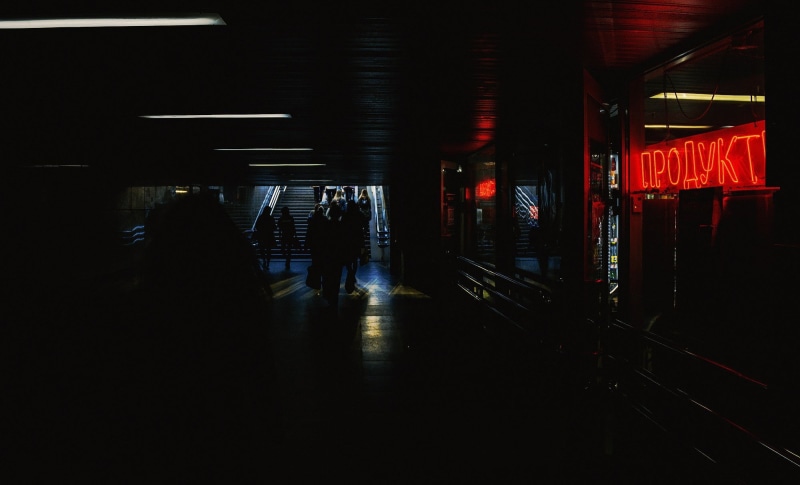 black, waiting, mode of transportation, illuminated, night, red, city, medium group of people, railroad station, travel, group of people, indoors, women