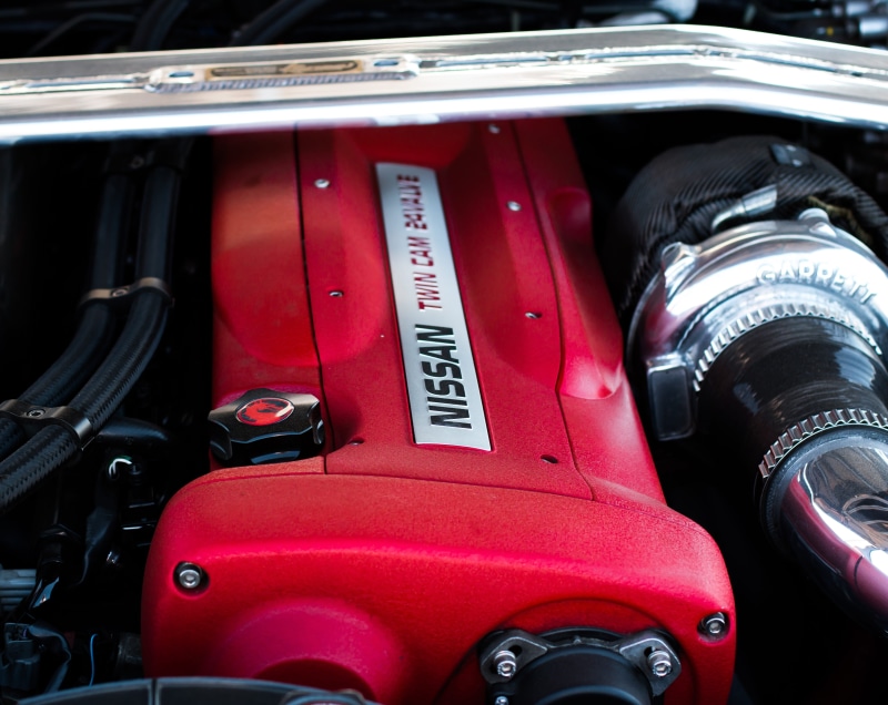 turbo, transportation, auto, day, text, land vehicle, mode of transportation, motor vehicle, stationary, nissan, vehicle part, selective focus, red, indoors