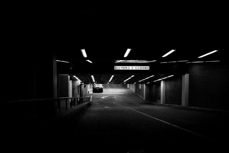 basement garage, photo, illuminated, direction, dark, light, public transportation, sign, built structure, parking garage, underground parking lot, empty