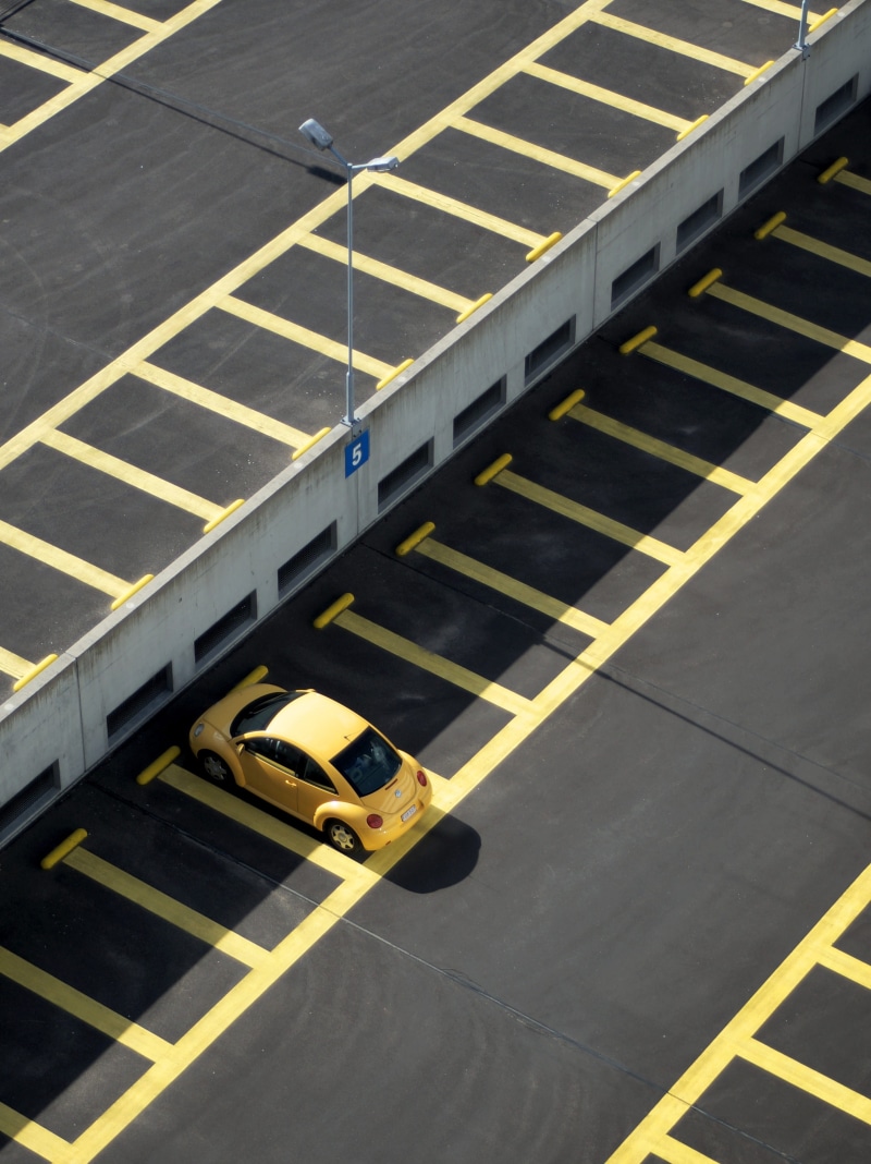 no people, vehicle, symbol, lamp, pattern, marking, asphalt, transportation, parking, street, mode of transportation, day, lot, volkswagen, parked, shade