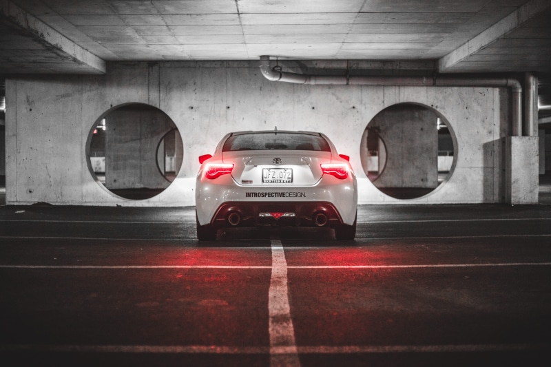 toyota, night, protection, city, red, street, motor vehicle, parking lot, communication, tail lights, sport, wood - material, parking garage, pavement