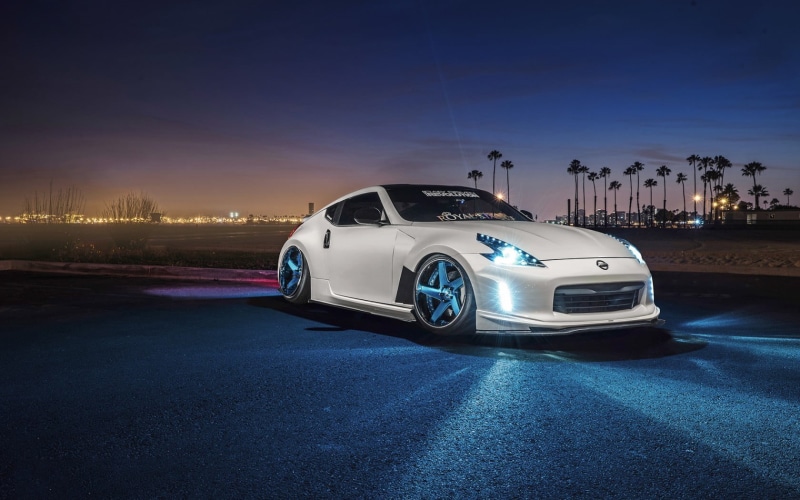 built structure, no people, blue, luxury, nature, motor vehicle, night, white cars, illuminated, city, street, speed, sports car, dusk, building exterior