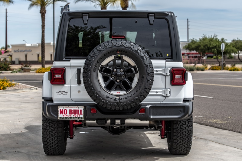 car yard, architecture, automotive, focus on foreground, jeep, nature, 5K, SUV, wrangler, back view, no people, truck, parking lot, car, off road, parking