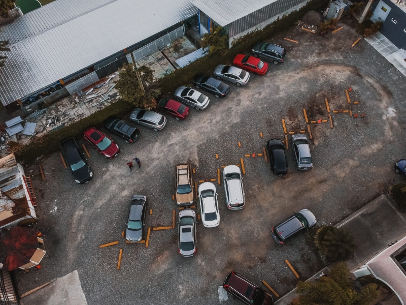 transportation, parking lot, day, mode of transportation, architecture, car, built structure, city, drone view, travel, no people, parked, high angle view
