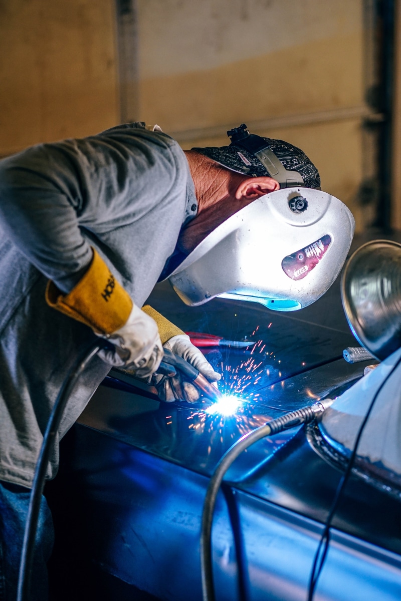 heat, workshop, automobile, wood, one person, tools, metalworking, three quarter length, mechanical, indoors, action, worker, labor, door, work tool, transportation system