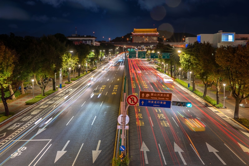 the way forward, mode of transportation, highway, sign, motor vehicle, outdoors, motion, urban, direction, building, car, cityscape, metropolis, building exterior