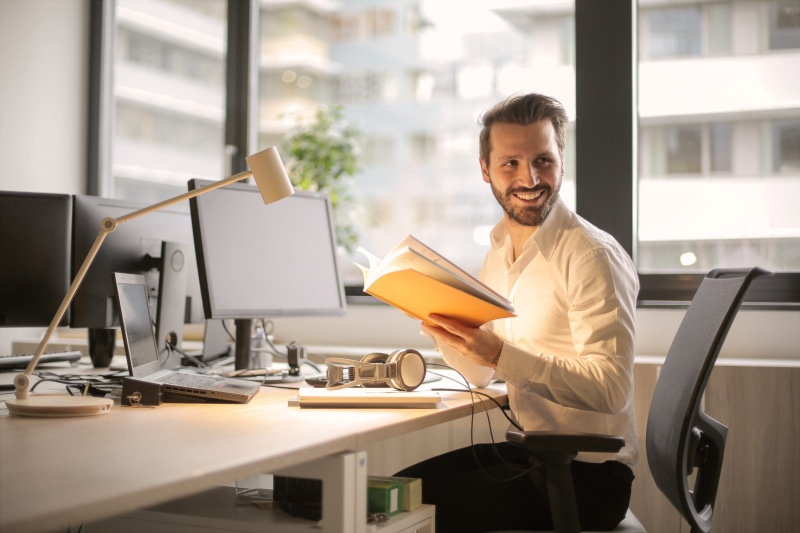 business person, indoors, adult, office, table, furniture, desk, 2K, one person, looking at camera, hands, portrait, new business, smiling, occupation