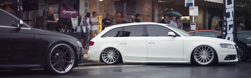 mode of transportation, white cars, white, vehicle, adult, cars, building exterior, motion, city, luxury, wheel, Audi, incidental people, architecture