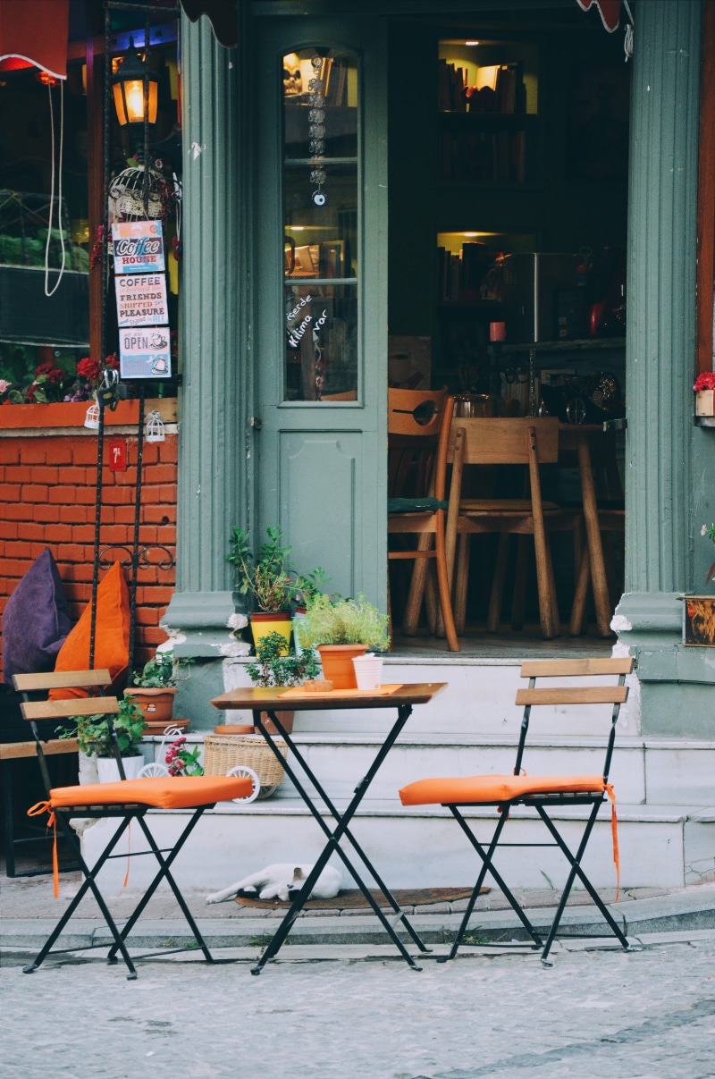 window, sidewalk cafe, daylight, no people, contemporary, building, empty, chair, door, outdoors, cafe, patio, doorway, furniture, travel, set, wood, coffee shop