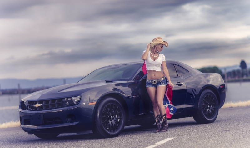 shorts, lifestyles, real people, beautiful woman, hairstyle, cloud - sky, young adult, standing, full length, hair, sky, outdoors, car, young women, Chevrolet Camaro