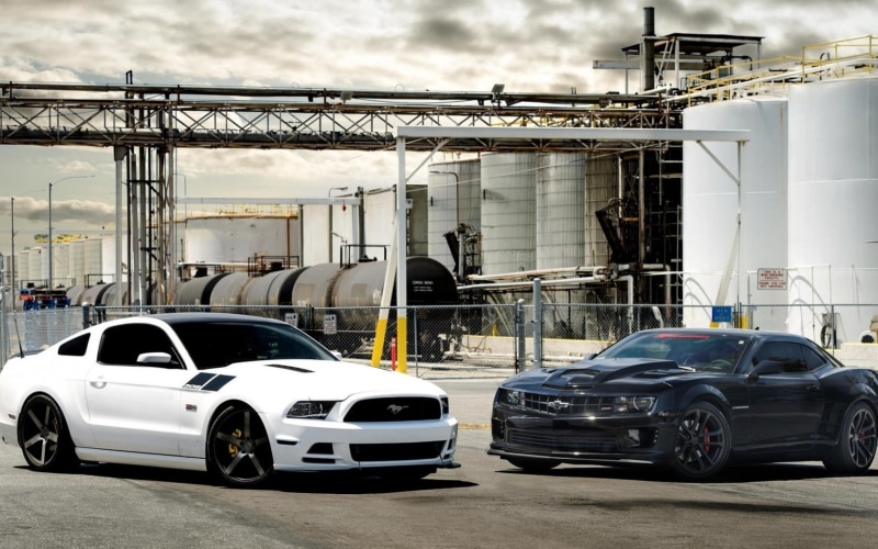 two, white, black, outdoors, Ford Mustang, transportation, metal, built structure, no people, Chevrolet Camaro, building exterior, city, road, car, motor vehicle