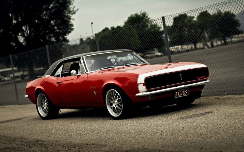 land vehicle, red, 1080P, focus on foreground, architecture, sky, car, mode of transportation, no people, transportation, vintage car, outdoors, Camaro