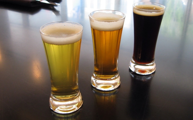 three, table, frothy drink, food and drink, household equipment, bar counter, no people, bar - drink establishment, vases, beer - alcohol, indoors, three objects