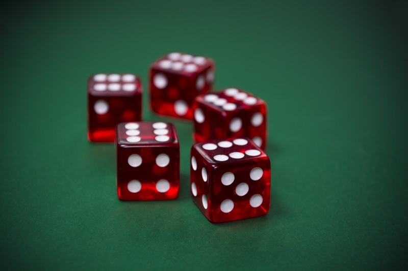 pleasure, casino, leisure activity, victory, green background, risk, gamble, five, no people, luck, studio shot, play, close-up, table, dice, players, red