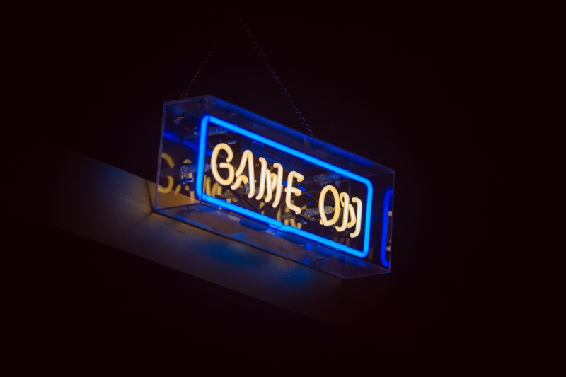 studio shot, western script, blue, close-up, dark, 5K, game, dining, television set, glowing, lighting equipment, turned, illuminated, sign, text, night