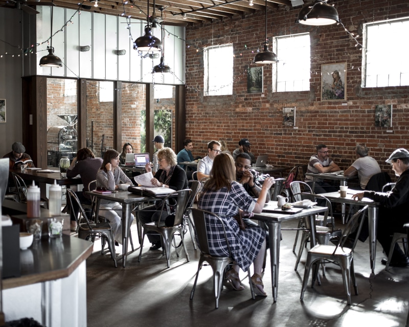 chair, coffee shop, people, group of people, daytime, large group of people, restaurant, meeting, food, inside, relax, young adult, sitting, chairs, brick wall