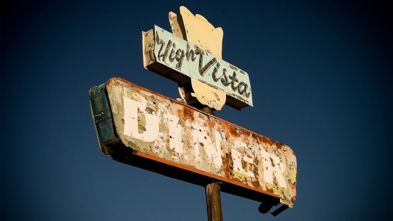 low angle view, sky, diner, South America, nature, direction, rusty, sign, metal, directional sign, clear sky, information, communication, blue, text, old
