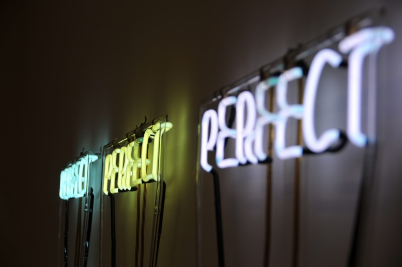 no people, neon light, night, sign, clothespin, hanging, indoors, light, business, nyc, word, illuminated, western script, wall, signage, number, large group of objects