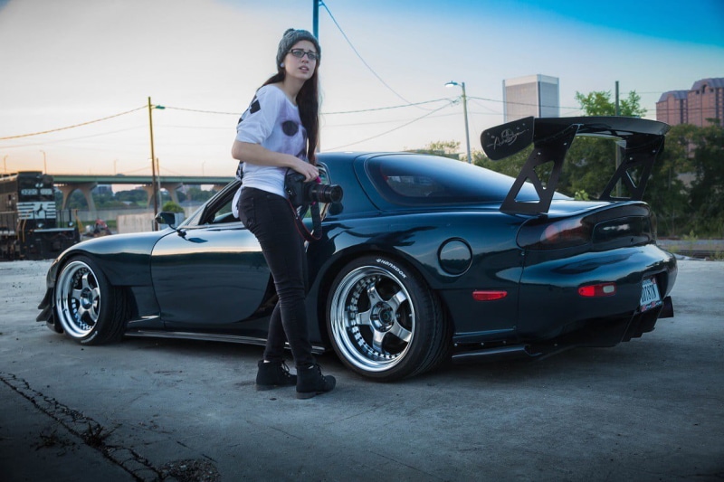 standing, leisure activity, lifestyles, coupe, 480P, architecture, Mazda RX-7, black, front view, city, brunette, women, looking at camera, car, glasses