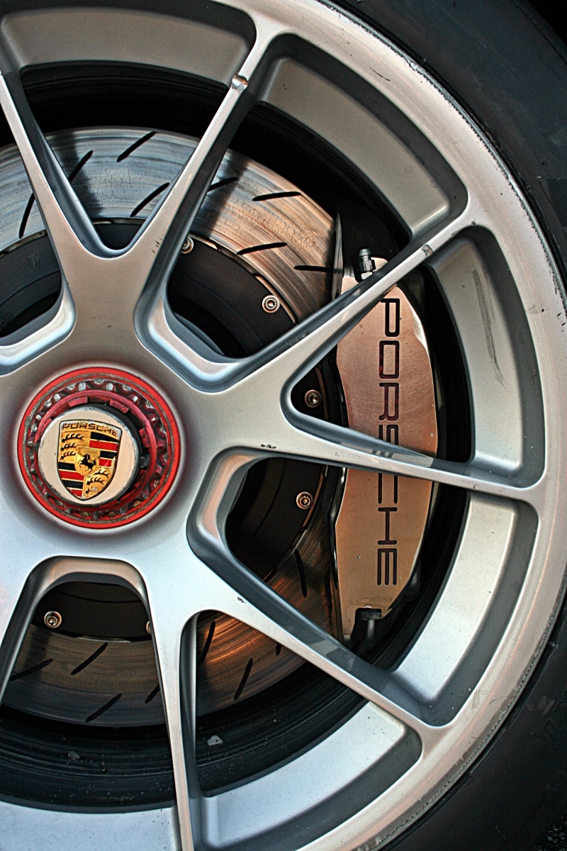 road, motor vehicle, Porsche, studio shot, metal, no people, control, race cars, transportation, indoors, shape, vehicle interior, high angle view, direction