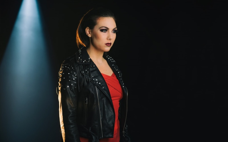 hairstyle, jacket, waist up, looking away, looking, young adult, black background, spotlights, looking at camera, adult, fashion, Elize Ryd, singer, black color