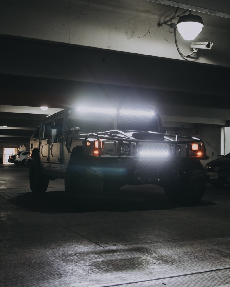 garage, motor vehicle, headlight, no people, transportation, light, gray, concrete, ceiling, pavement, wheel, suv, badass, night, alloy wheel, land vehicle