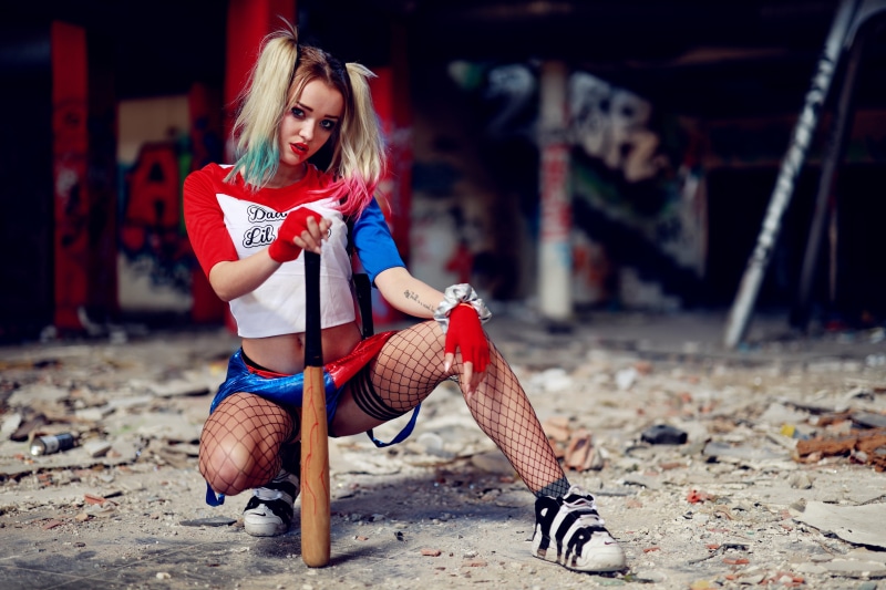 joker, long hair, makeup, harley quinn, footwear, one person, hair, beautiful woman, cosplay, holding, women, crazy, full length, front view, quinn, casual clothing