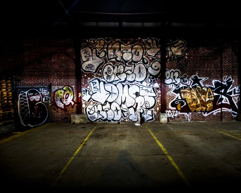building exterior, car, view, parking lot, multi colored, wall, motorcycle, architecture, asphalt, street art, vehicle, mural, bike, painting, building