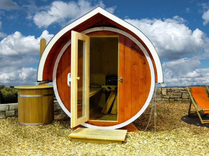 no people, outdoors, architecture, yellow, cabin, wooden, relax, sunlight, land, house, cloud - sky, sky, sauna, brown, barrel, day, built structure, wood