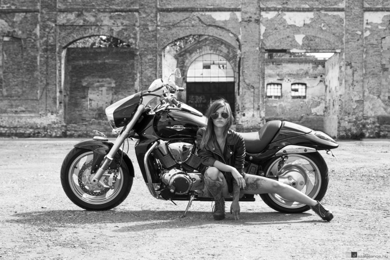 casual clothing, day, legs, portrait, real people, women, touring, one person, sitting, leather clothing, spread legs, high heels, building exterior, architecture