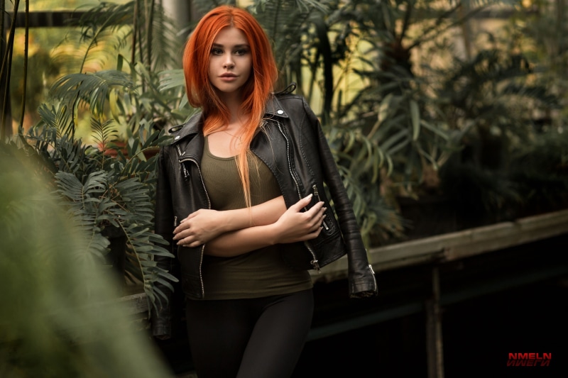 Nika Meln, depth of field, leggings, black jackets, T-shirt, bokeh, Dana Bounty, 2K, plants, women, leather jackets, portrait, redhead, model, greenhouse